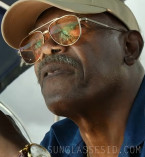 Samuel L. Jackson wears gold Akoni Helios sunglasses in the movie Just Play Dead.