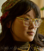 Thaddea Graham wears yellow Jimmy Fairly The Headlight eyeglasses in Margo's Got Money Troubles.