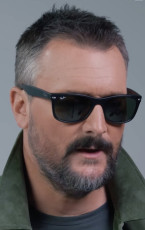 Country music singer-songwriter Eric Church wears matte black Ray-Ban RB2132 New Wayfarer sunglasses.