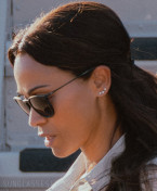 Zoe Saldaña wears black Ray-Ban RB4171 Erika sunglasses in the series Lioness (2024).