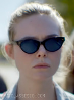 Elle Fanning wears black cat-eye sunglasses in the AppleTV+ series Margo's Got Money Troubles.