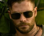 Chris Hemsworth wears an unidentified pair of gold sunglasses in Extraction.