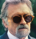 Dennis Boutsikaris wears John Varvatos V605 UF sunglasses in the funeral scene in Sugar.