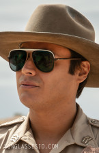 Kiowa Gordon wears dark sunglasses with a white band in the series Dark Winds.