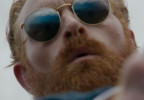 Kristofer Hivju wears gold Ray-Ban RB3637 New Round sunglasses in the Guy Ritchie movie In The Grey.