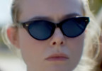 Elle Fanning wears black cat-eye sunglasses in the AppleTV+ series Margo's Got Money Troubles.