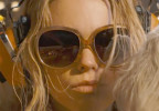 Milly Alcock wears oversized sunglasses in the movie Supergirl.