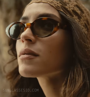Adria Arjona wears Saint Laurent SL 567 sunglasses in The Thomas Crown Affair.