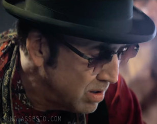 Nic Cage always wears interesting sunglasses, often with red lenses, but in this case he outdid himself with these unique cross shaped  glasses.