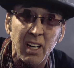 Nicolas Cage wears unique cross-shaped sunglasses wih gradient lenses in Gunslingers.